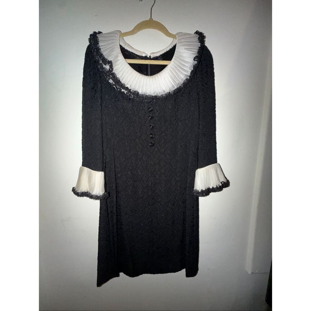 A vintage dress fits a S/M black and white ruffled lace dress with a few elegant